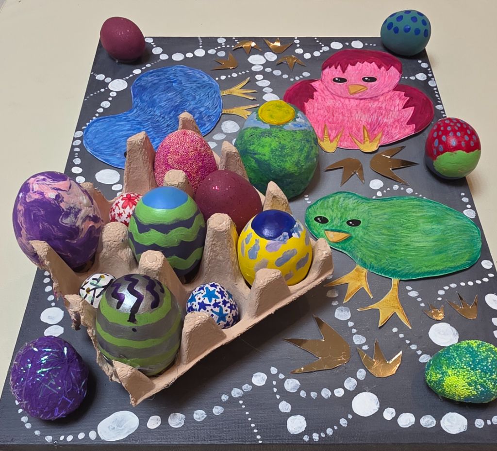 45-degree view of the same mixed-media piece, showing the depth of the carton and the sculpted surface of each egg.